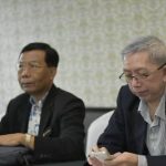 Senior Thai attorneys from Ray Law reviewing case materials during a legal meeting.